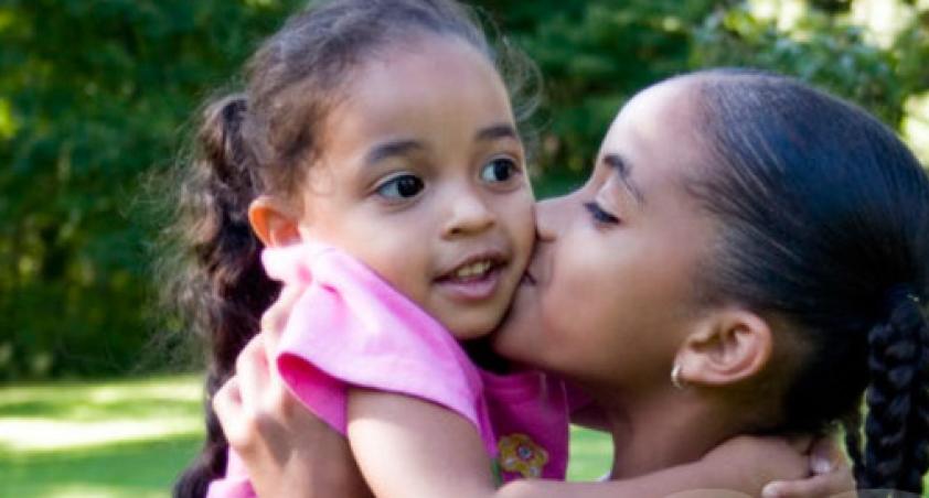 Women kissing girl